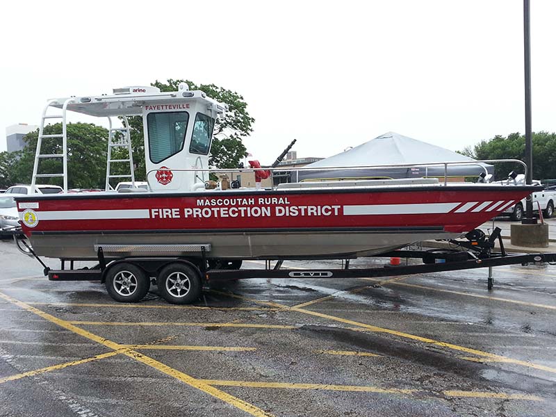 fire protection district boat on a trailer in a parking lot