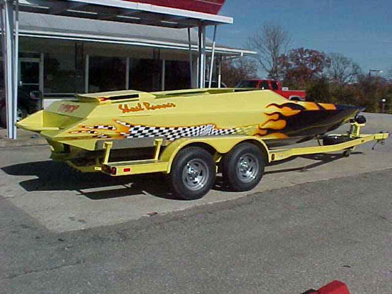 yellow shoal runner boat on a trailer