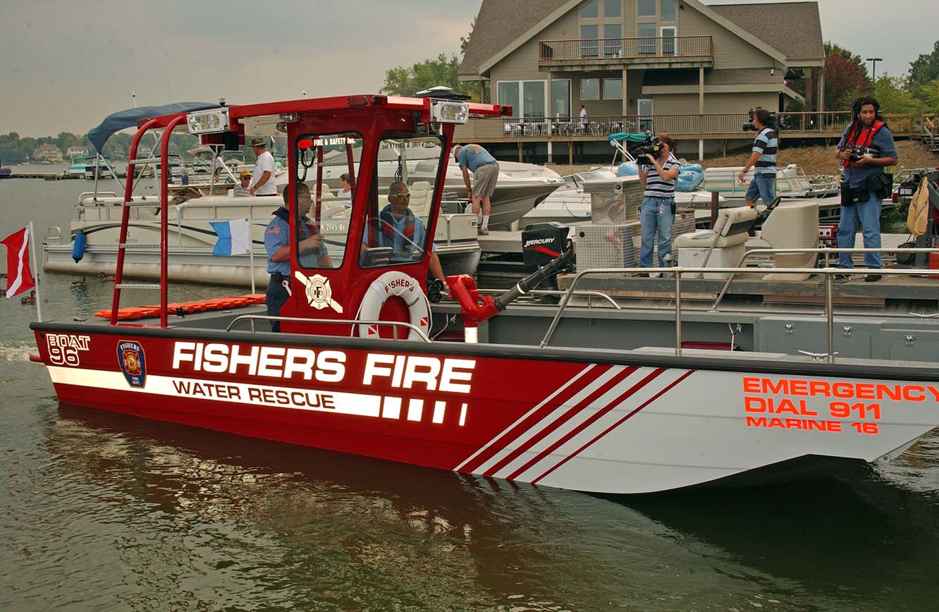 Fishers fire water rescue boat docked with other boats around